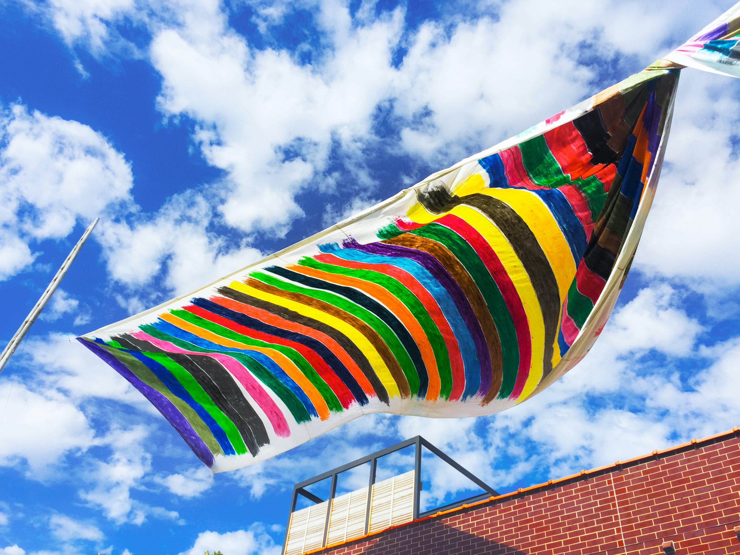A banner of painted stripes waft over a rooftop in Chicago's Ukrainian Village as a symbol of unity and diversity.
