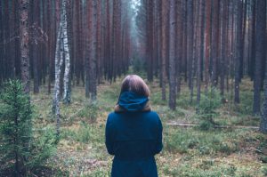 Woman standing in woods