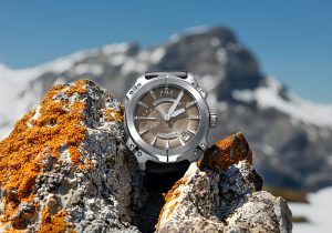 macro photography of round silver-colored and brown chronograph watch on stones